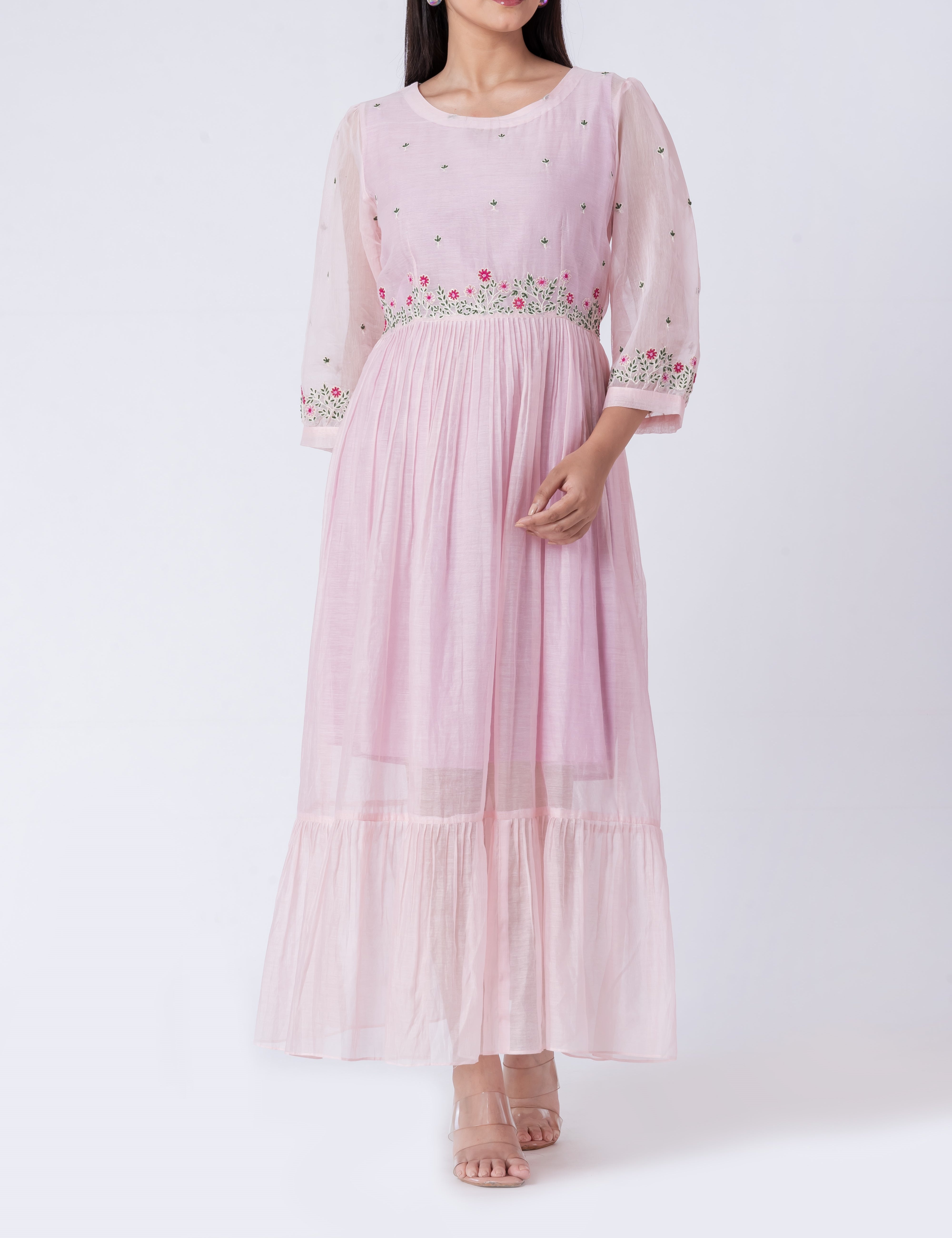  Close-up shot of the intricate floral embroidery on the cotton silk dress fabric.