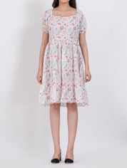Floral print dress featuring puff sleeves and tiered A-line shape for an effortless look