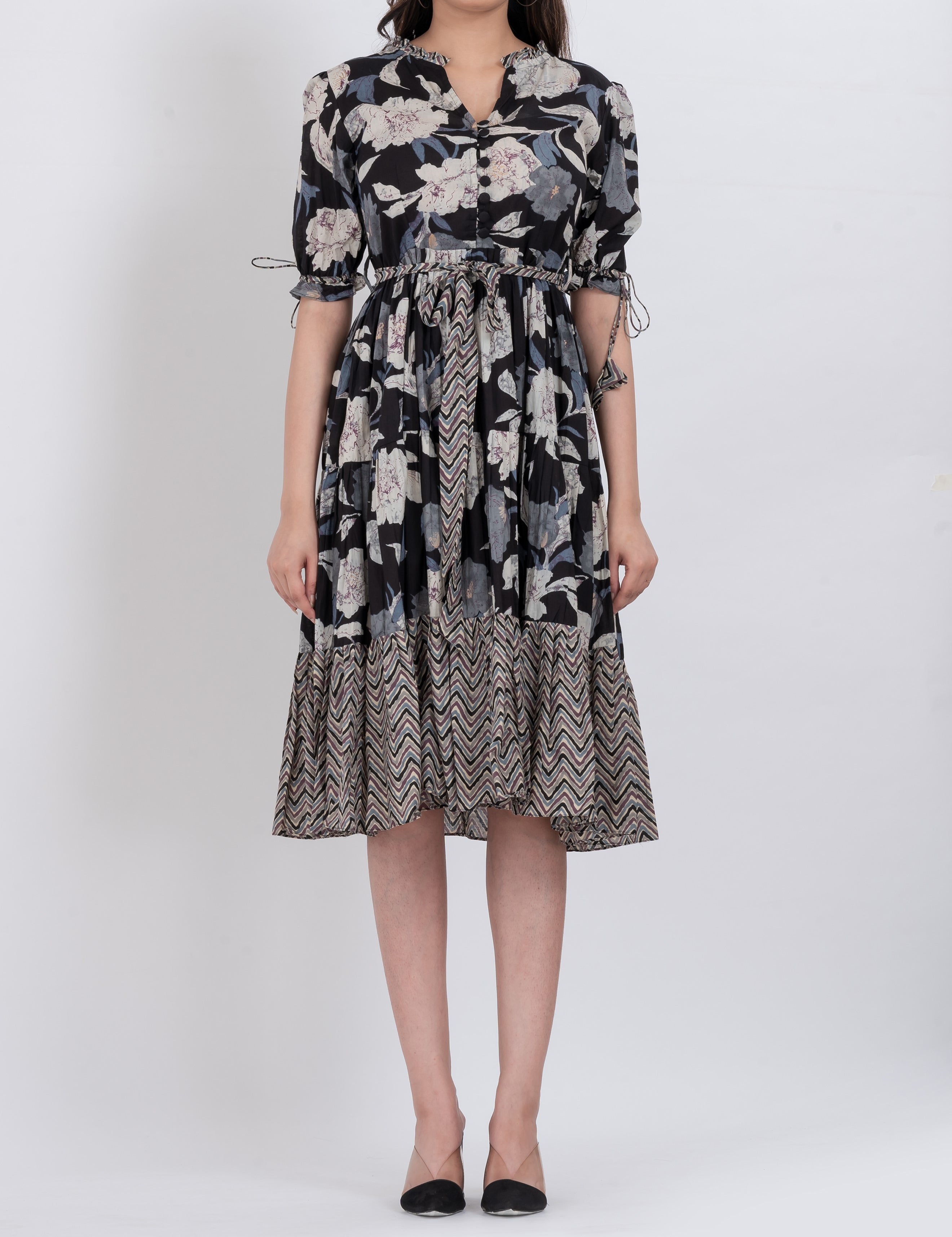 Front view of a floral tiered midi dress with bell sleeves and a V-neckline, showcasing a feminine and boho-inspired look.